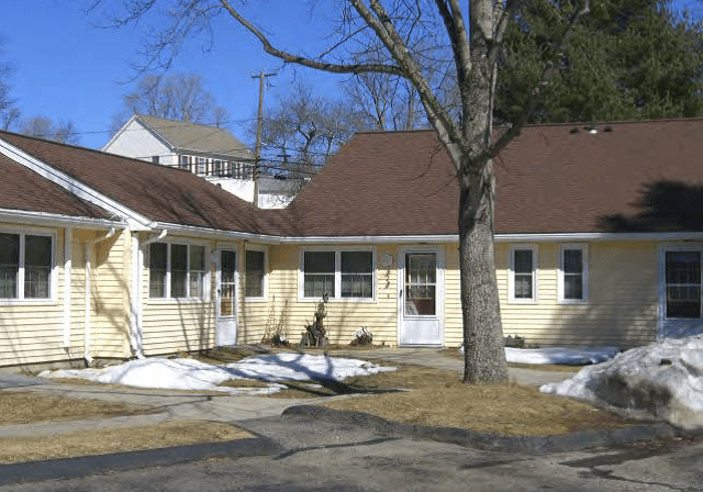 Sunny day at a yellow residential home.