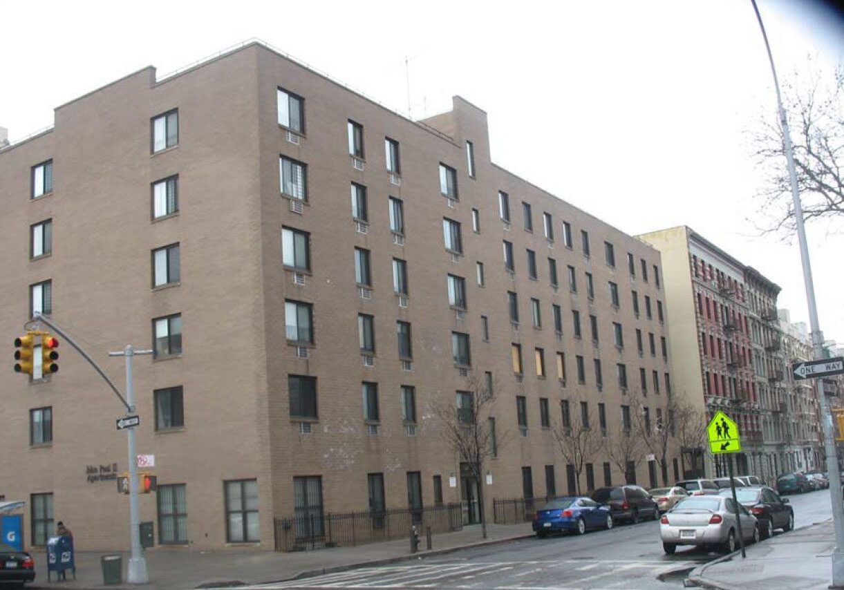 Brown brick building in urban neighborhood.