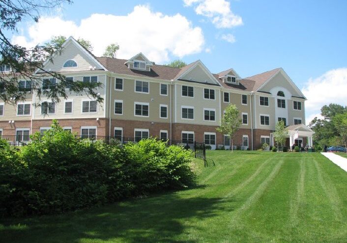 Large residential building with green lawn